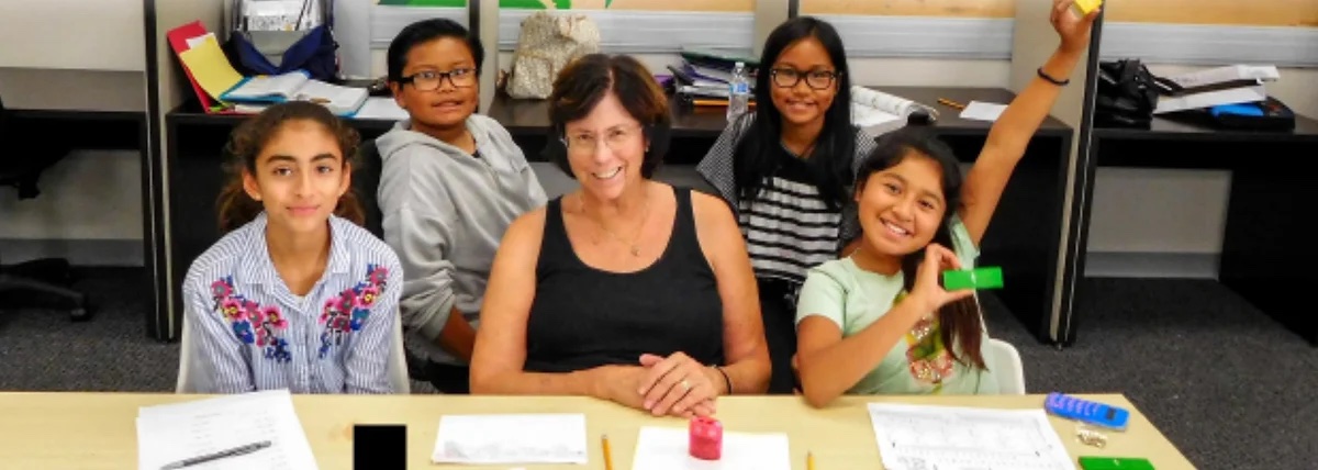 Volunteer working on homework with children